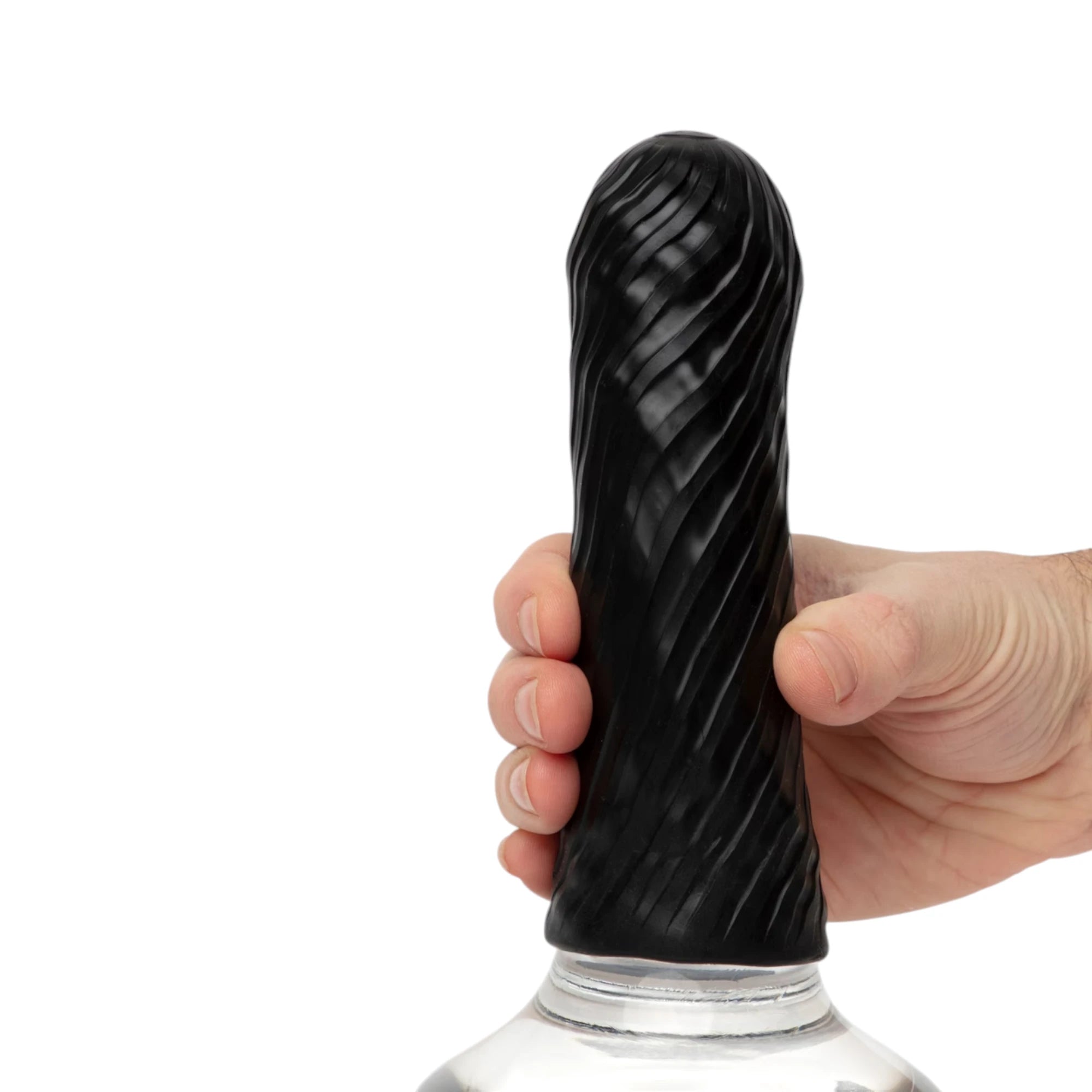 Arcwave Ghost black reversible silicone male stroker sleeve held in hand showing spiral textured exterior, displayed on clear bottle stand against white background