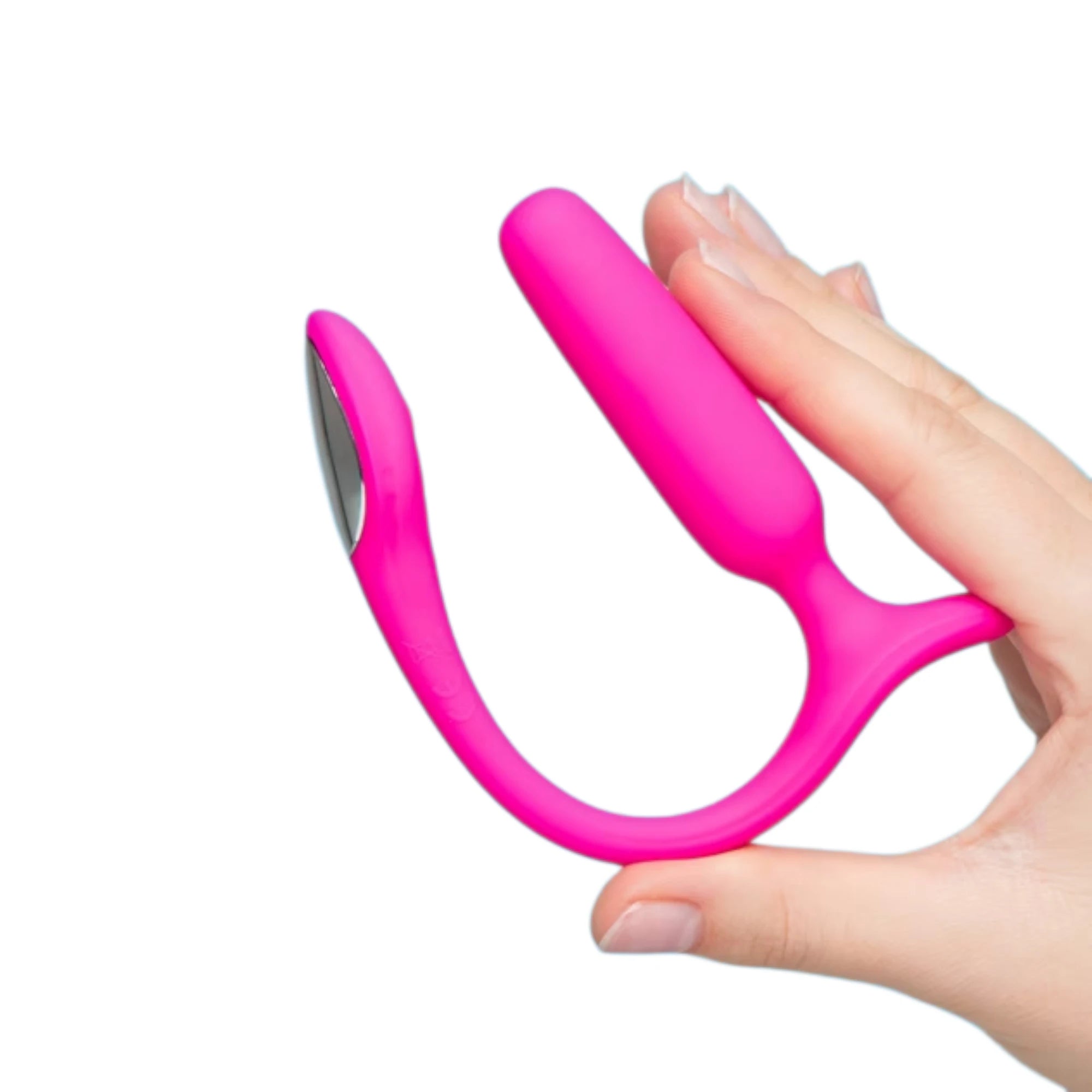 Lovense Lush anal vibrating butt plug in pink shown held in a hand for size reference, highlighting the tapered plug shape and curved tail with a flat external section against a white background.