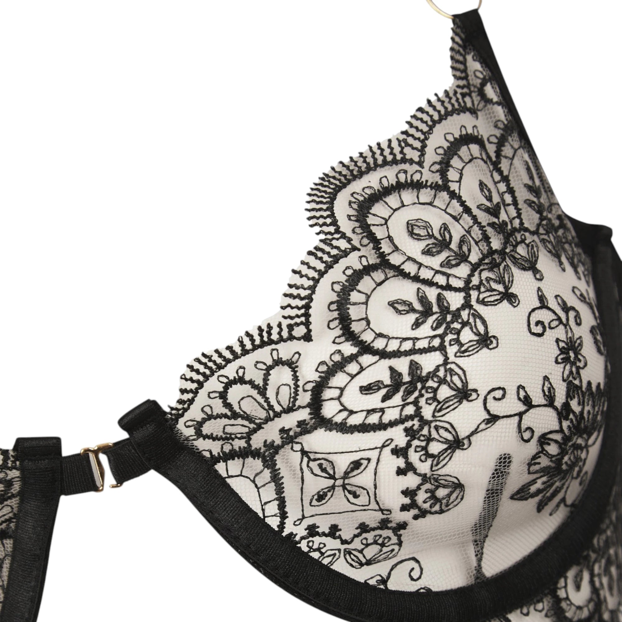 The Lormi Lingerie Embroidered Lace Harness Set (3 Piece) — Black & Ivory with a close-up view of the ivory mesh bra cup with black embroidered lace detailing and black strap hardware, shown on a plain white background