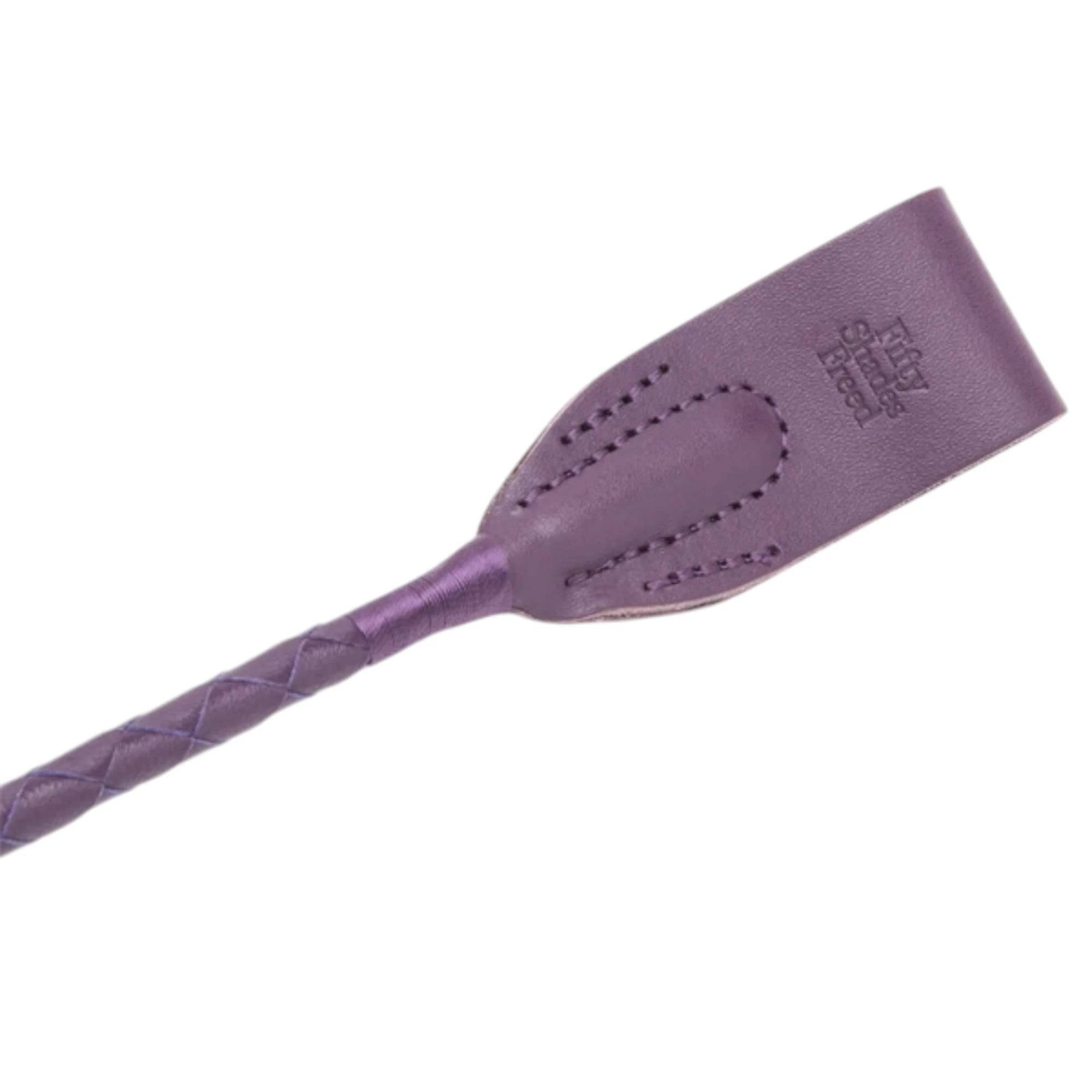 Close-up of the Fifty Shades Freed Cherished Collection riding crop tip, showing the purple stitched leather-style paddle end with embossed Fifty Shades Freed branding and the braided handle detail against a white background.