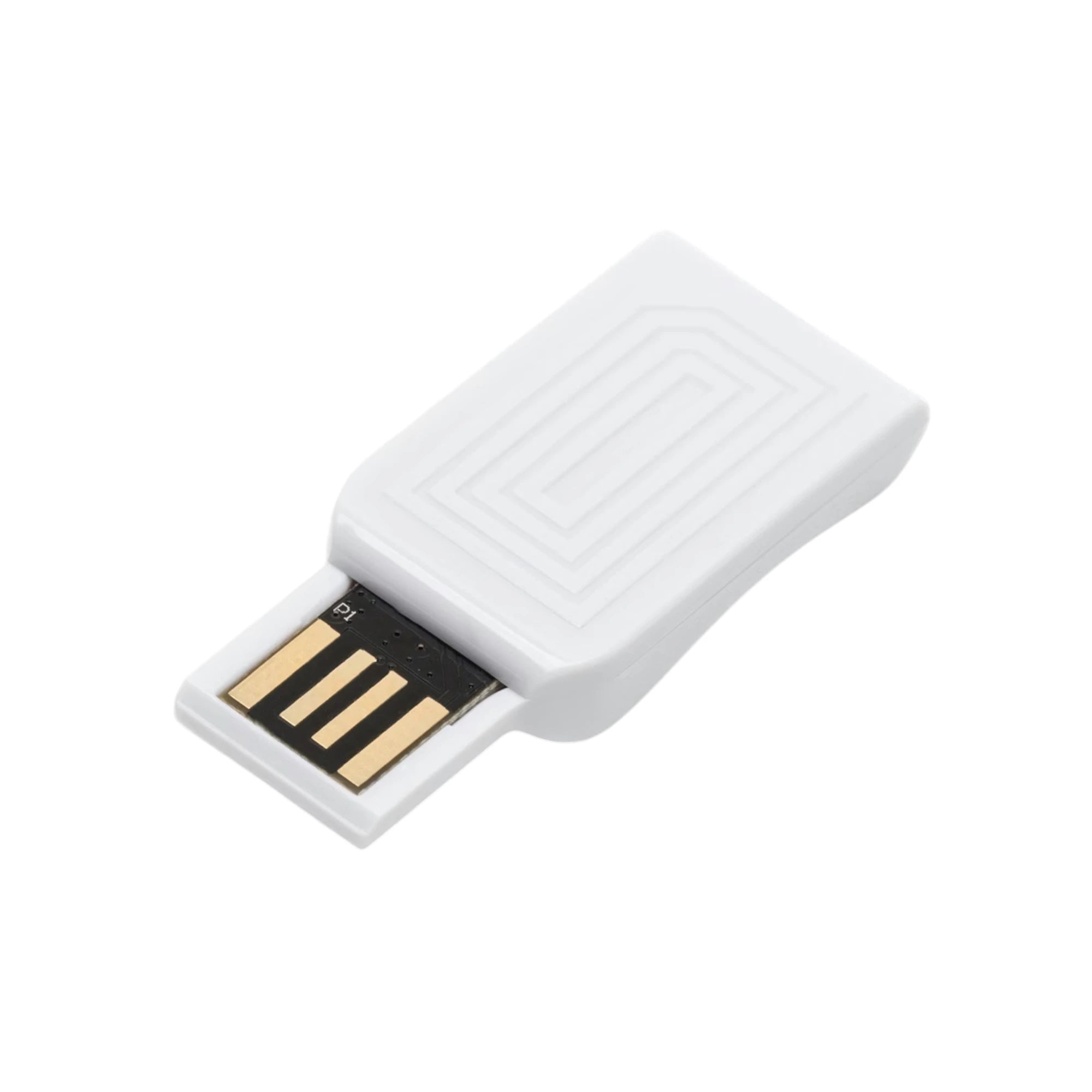 Lovense white USB Bluetooth adaptor shown from 3/4 angle displaying rectangular white body with concentric square pattern detail, gold and black USB connector with multiple contact pins, and smooth finish against white background