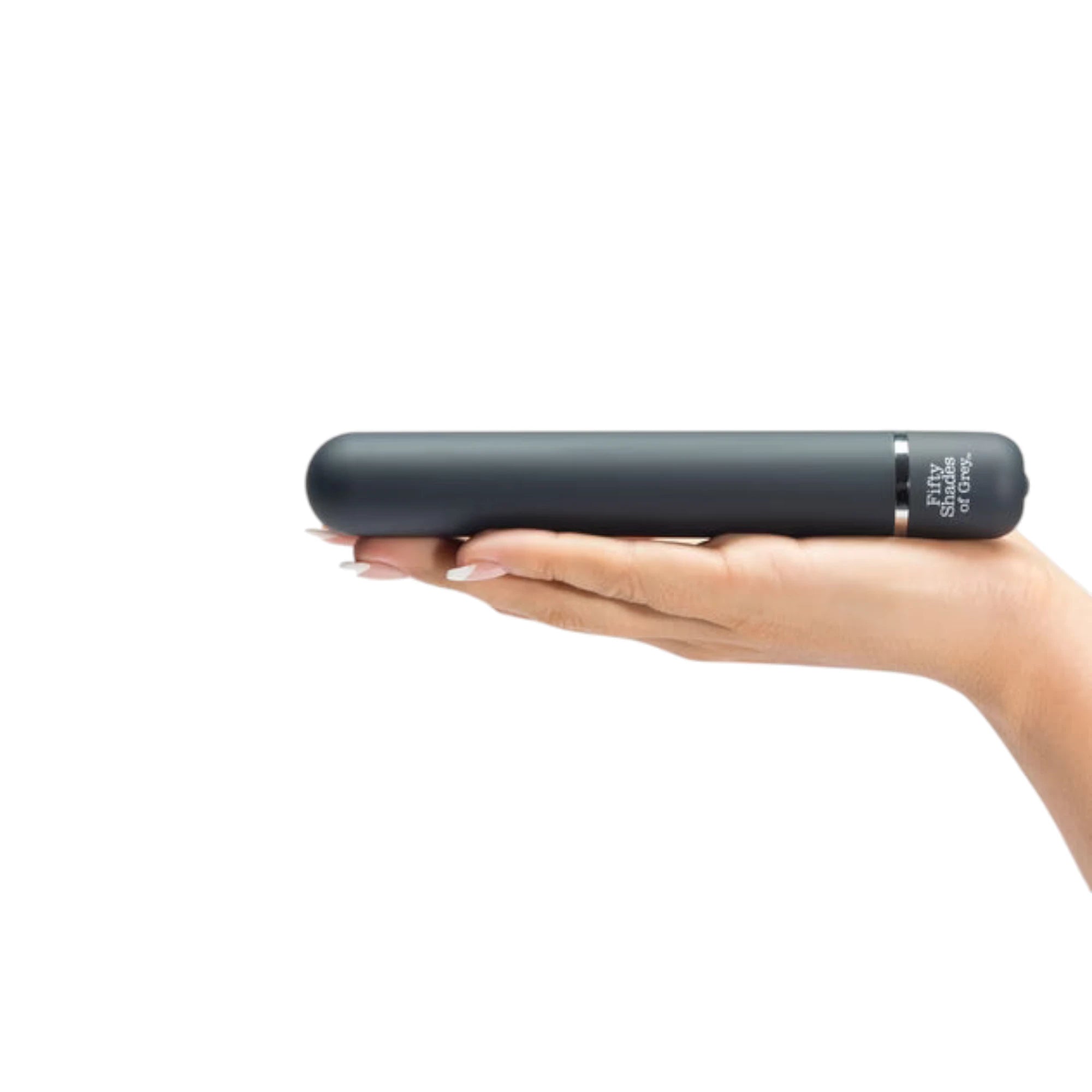 Fifty Shades of Grey Charlie Tango classic vibrator in black held in open palm displaying smooth cylindrical shaft, rounded tip, control button with Fifty Shades of Grey branding, and silver accent bands against white background