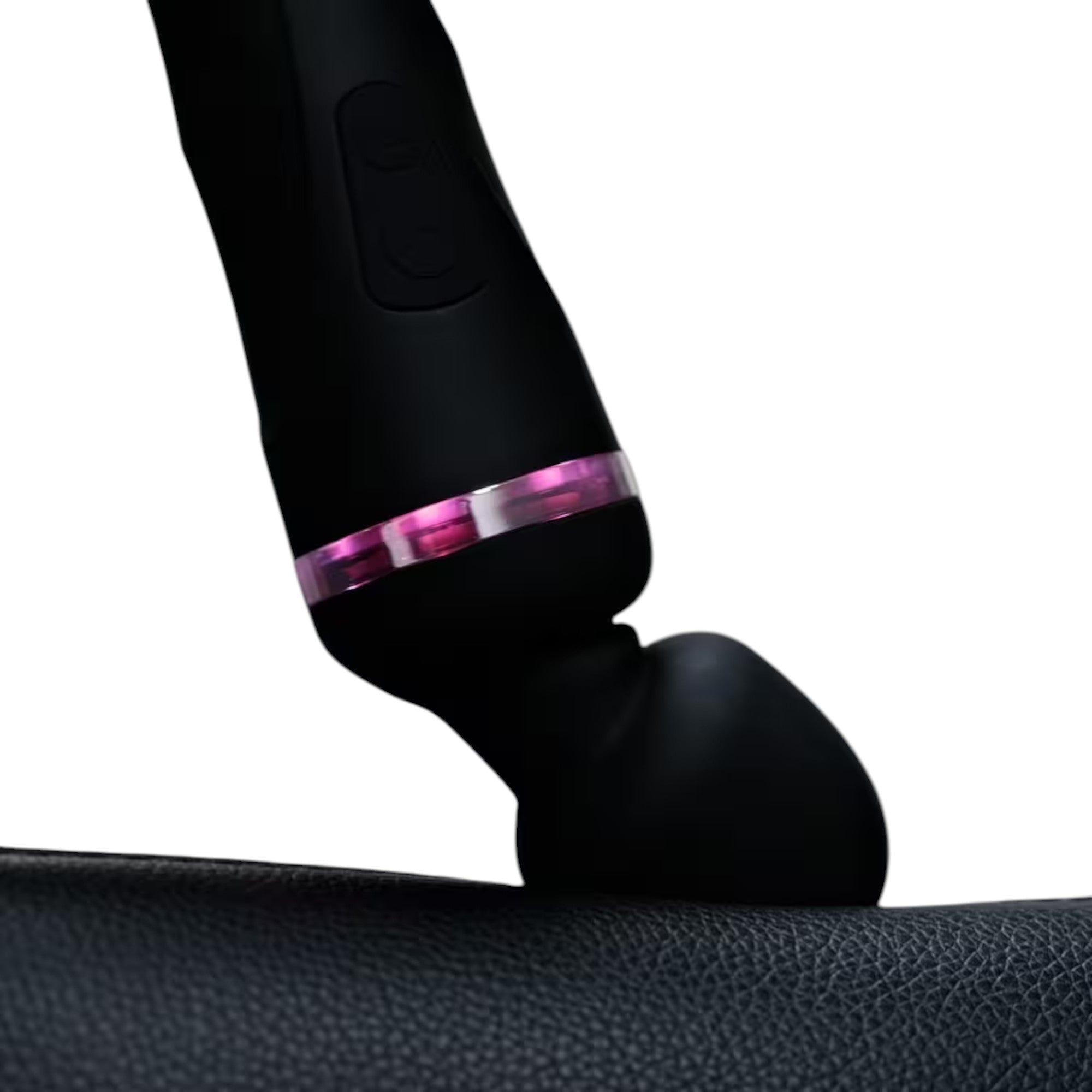 Lovense Domi 2 black rechargeable wand vibrator shown in close-up detail displaying rounded massage head, cylindrical handle with control buttons, illuminated purple LED accent band, and smooth silicone finish positioned against textured fabric surface against white background