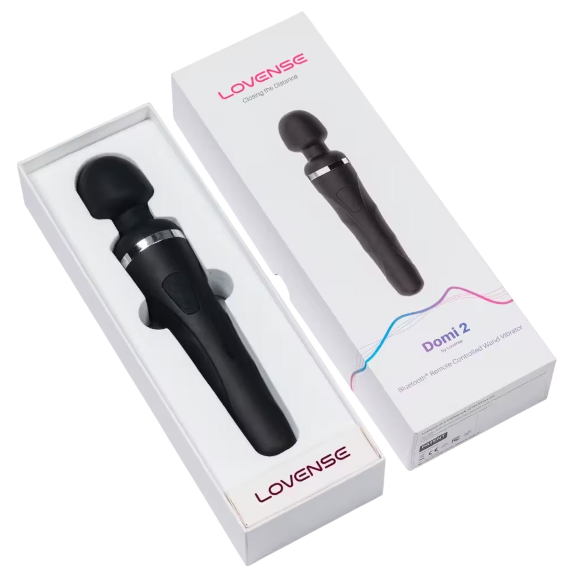 Lovense Domi 2 packaging boxes displayed open showing two white boxes with Lovense branding, black rechargeable wand vibrators with rounded heads and silver accent bands nestled in white foam packaging, 'Closing the Distance' tagline, 'Domi 2' product name, and 'Bluetooth Remote-Controlled Wand Vibrator' descriptor against white background