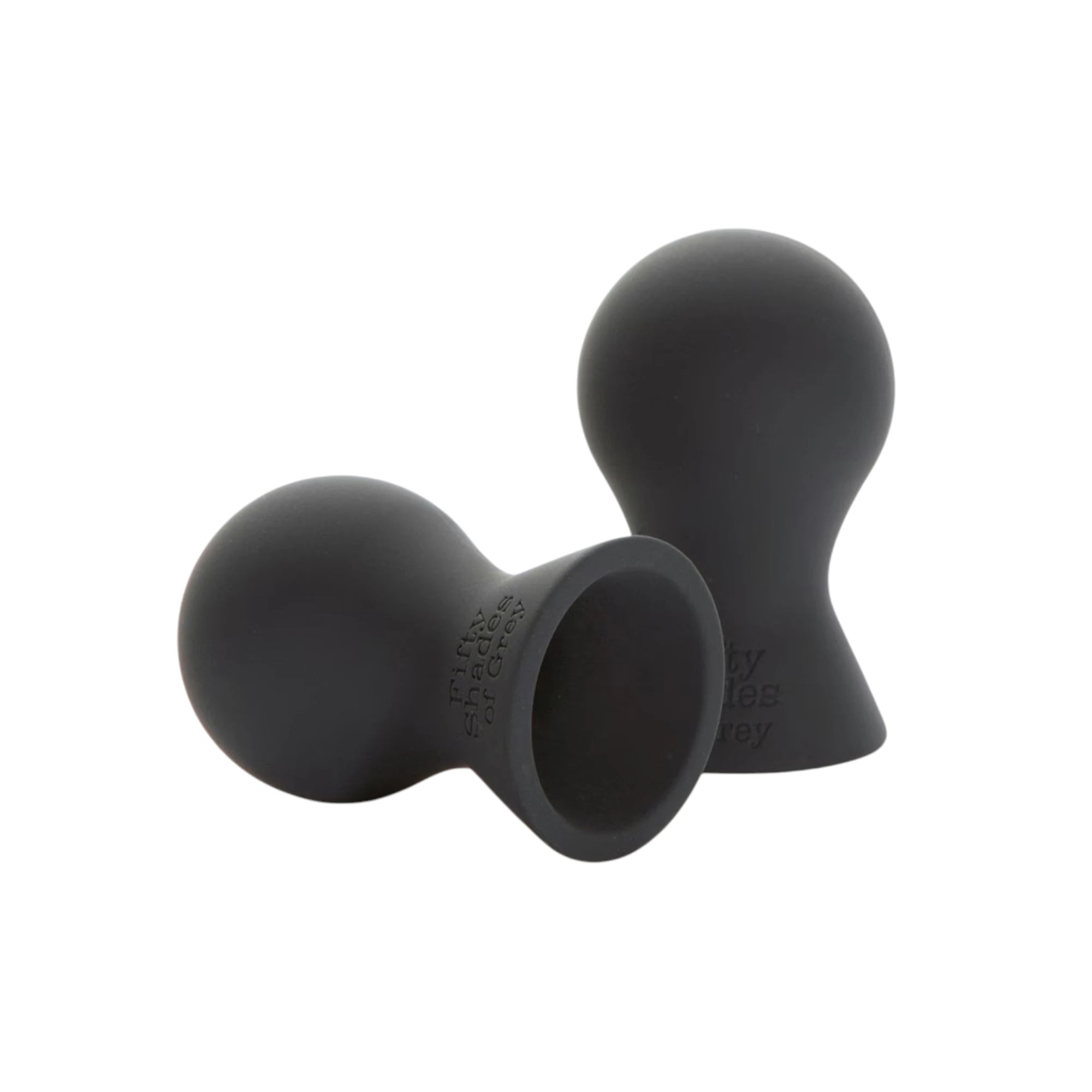 Fifty Shades of Grey Nothing but Sensation nipple suckers in black silicone shown from front displaying two rounded suction cups with textured interiors, one cup shown separately, and Fifty Shades of Grey branding against white background