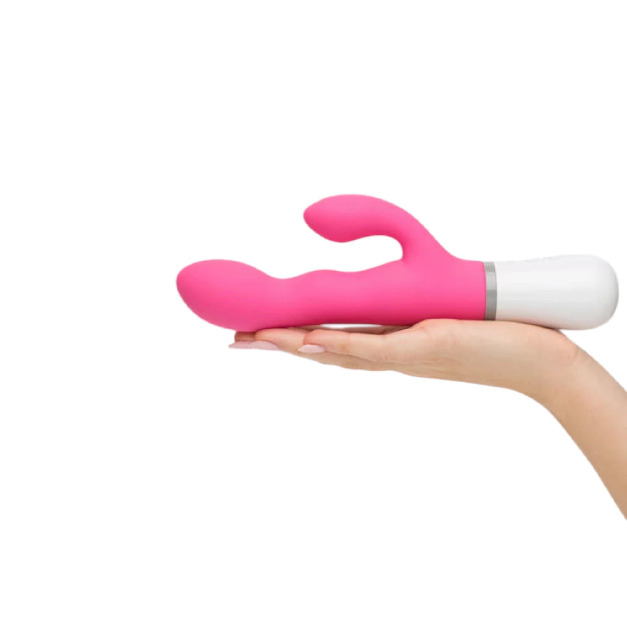 Lovense Nora hot pink and white rotating rabbit vibrator held in open palm displaying curved dual-stimulation arms, rounded clitoral bulb, internal rotating arm, white handle with grey accent band, and ergonomic size against white background