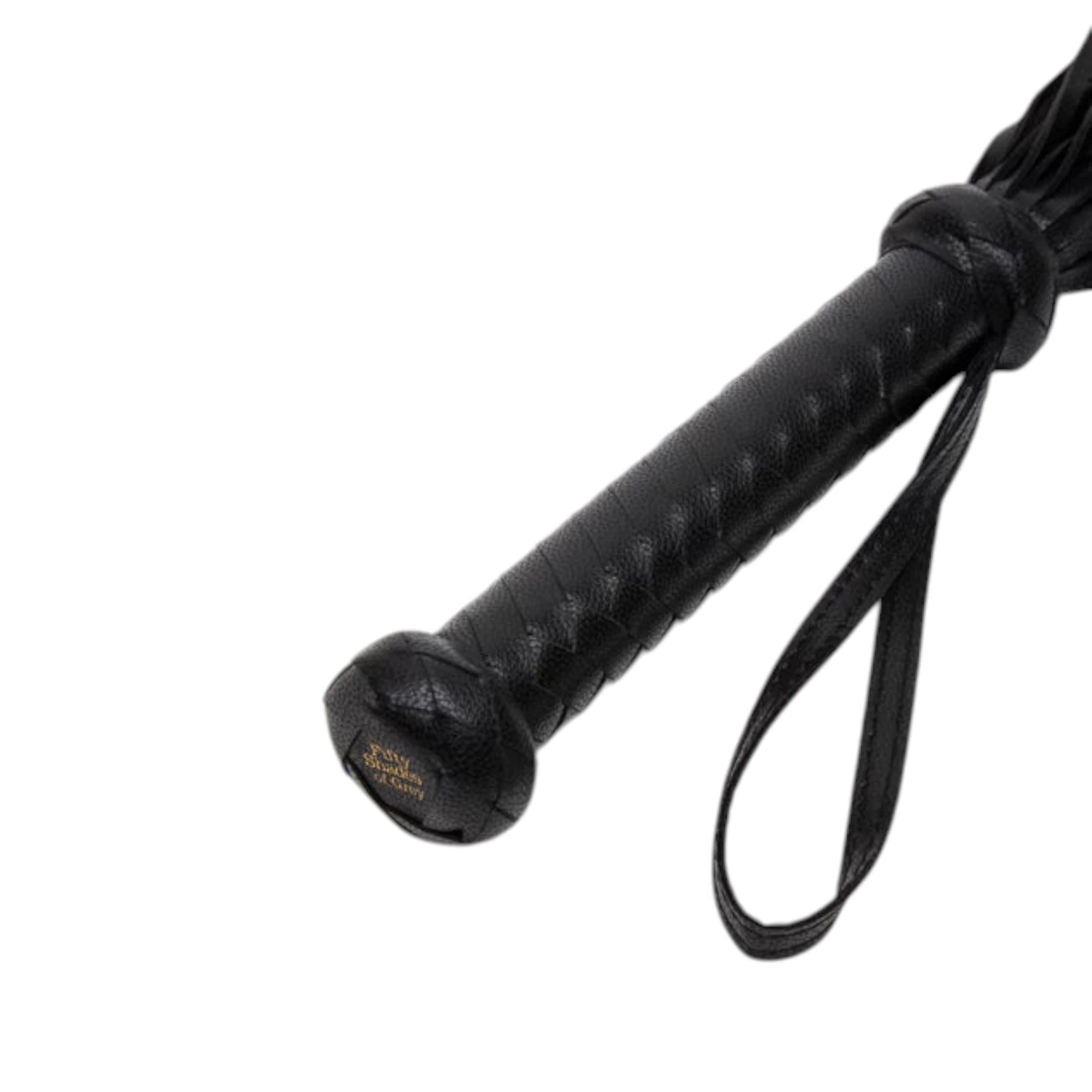Fifty Shades of Grey Bound to You faux leather flogger in black shown close up displaying braided textured handle with gold Fifty Shades of Grey branding, wrist loop, and multiple leather tassels against white background