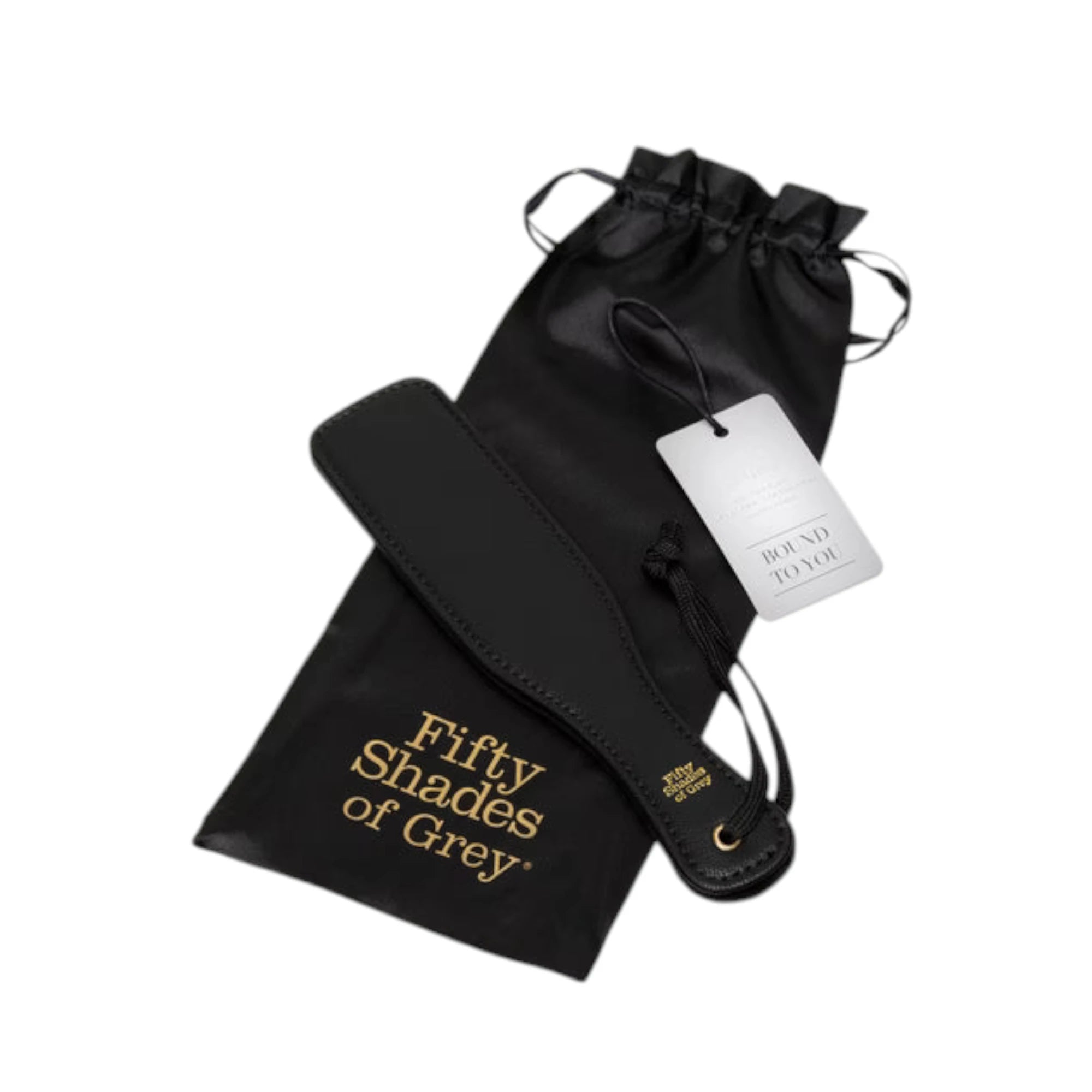 Fifty Shades of Grey Bound to You faux leather small spanking paddle in black displayed with black satin storage pouch featuring drawstring closure and 'Fifty Shades of Grey' gold branding, product tag attached, showing flat paddle head with wrist strap and gold grommet against white background