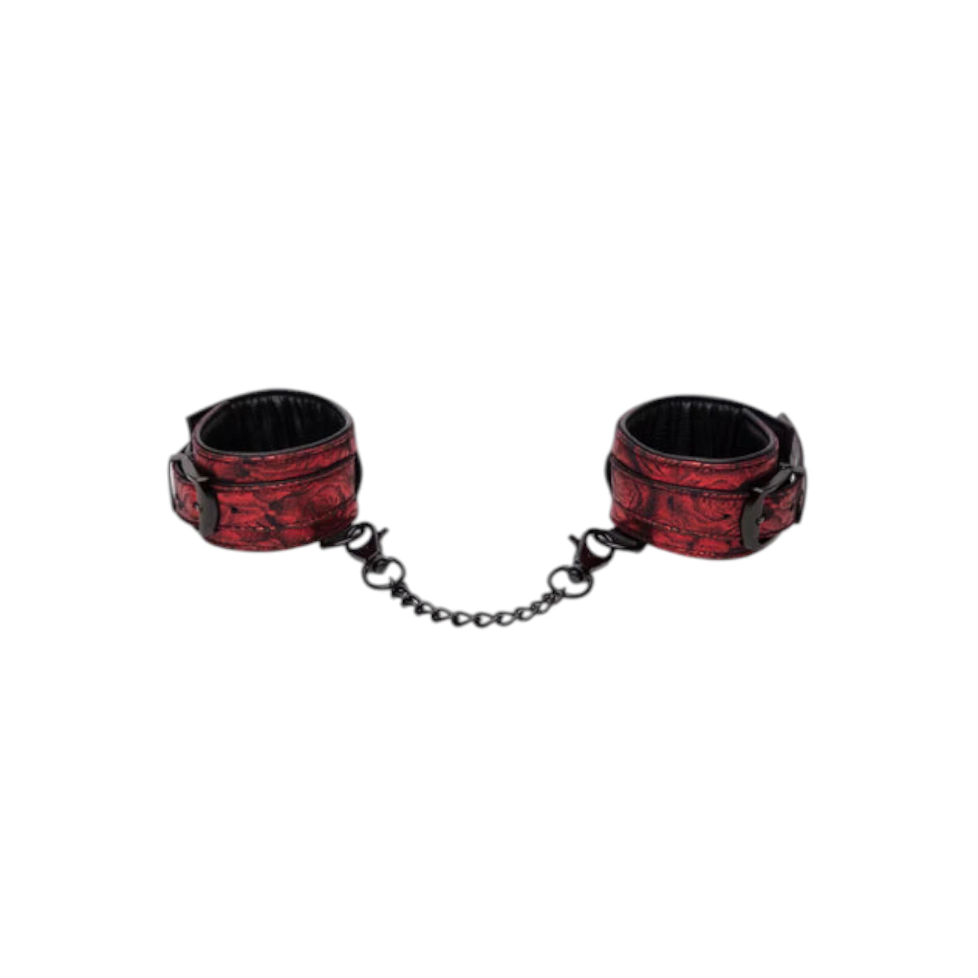 Fifty Shades of Grey Sweet Anticipation reversible faux leather wrist cuffs in burgundy and black jacquard pattern shown from above displaying two padded cuffs with black hardware, D-ring attachment points, and connecting chain against white background