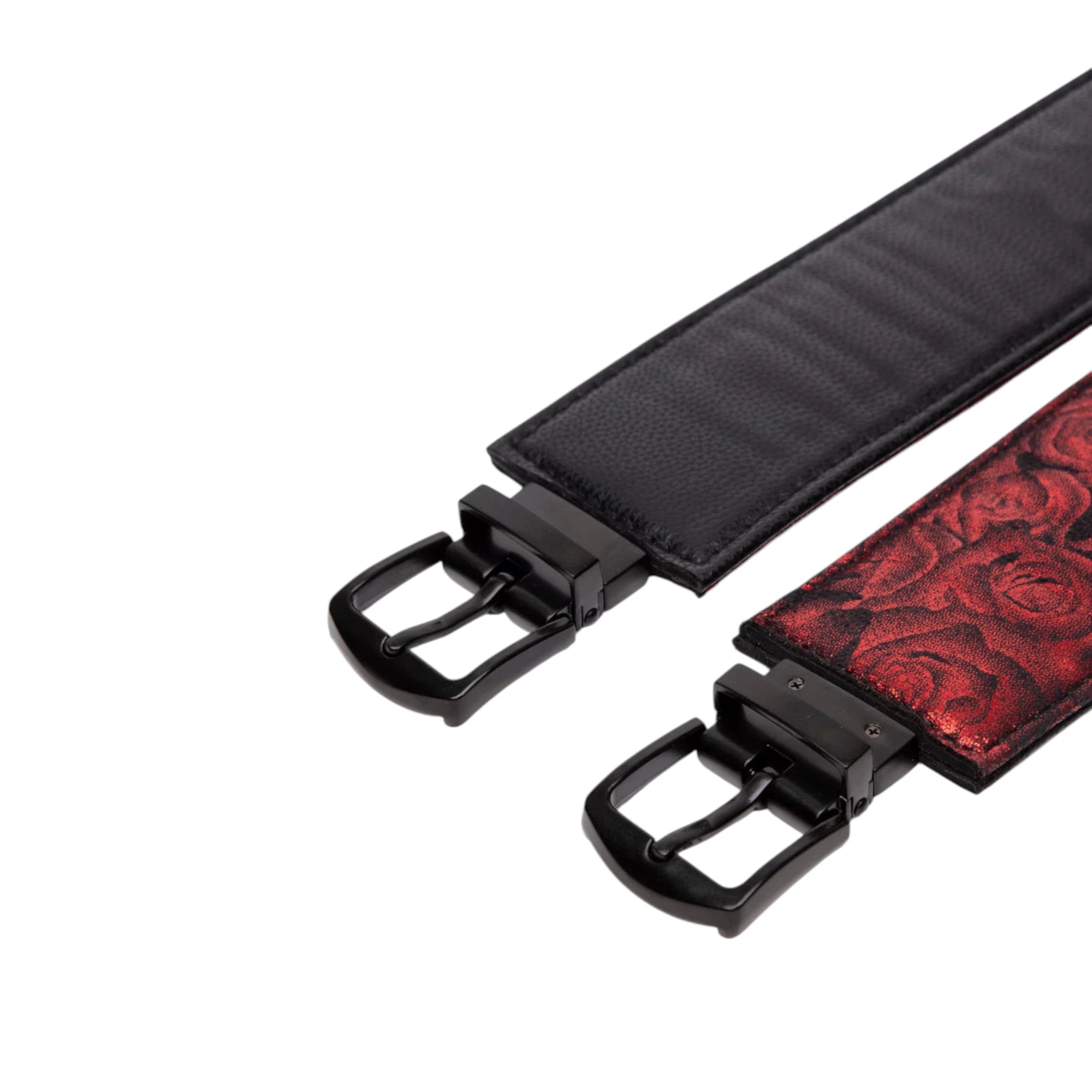 Fifty Shades of Grey Sweet Anticipation reversible faux leather wrist cuffs shown from side displaying black textured exterior and burgundy jacquard interior lining, adjustable buckle straps with black hardware against white background