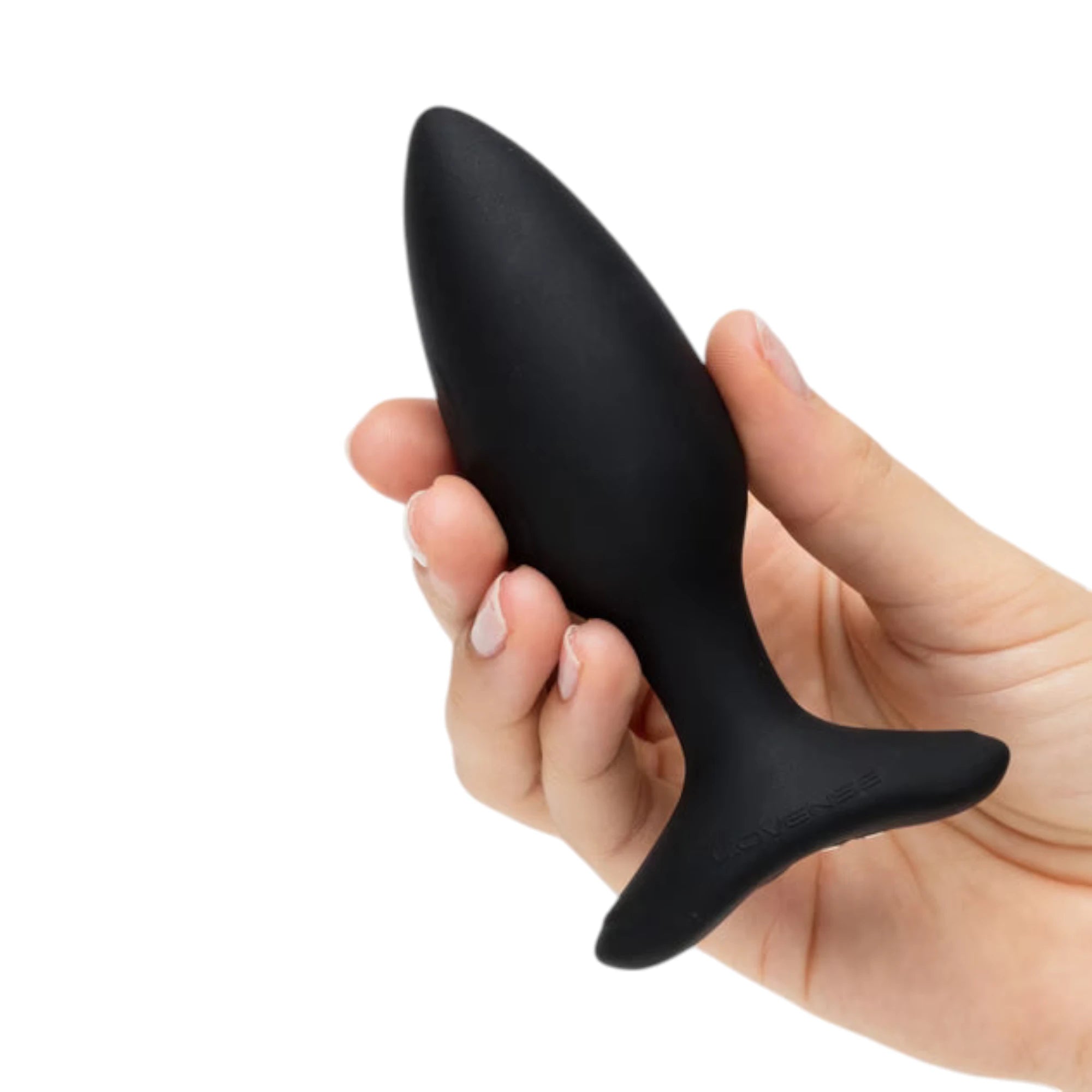 Lovense Hush 2 black vibrating butt plug held in hand displaying tapered pointed tip, smooth silicone body, flared triangular base, compact size, and ergonomic shape against white background