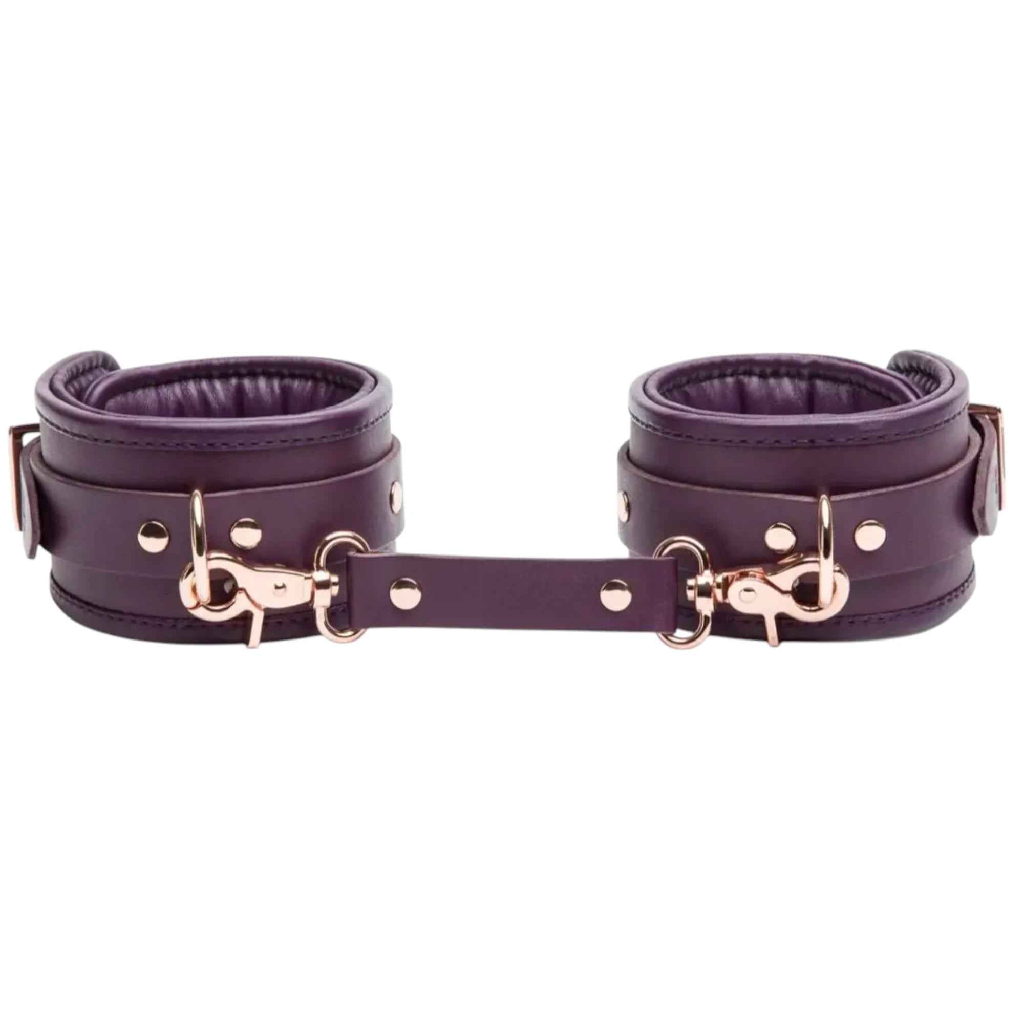  Fifty Shades Freed Cherished Collection leather ankle cuffs in purple, shown as a pair with padded interiors, rose-gold rivets and D-ring hardware, connected by a matching purple strap with metal clips against a white background