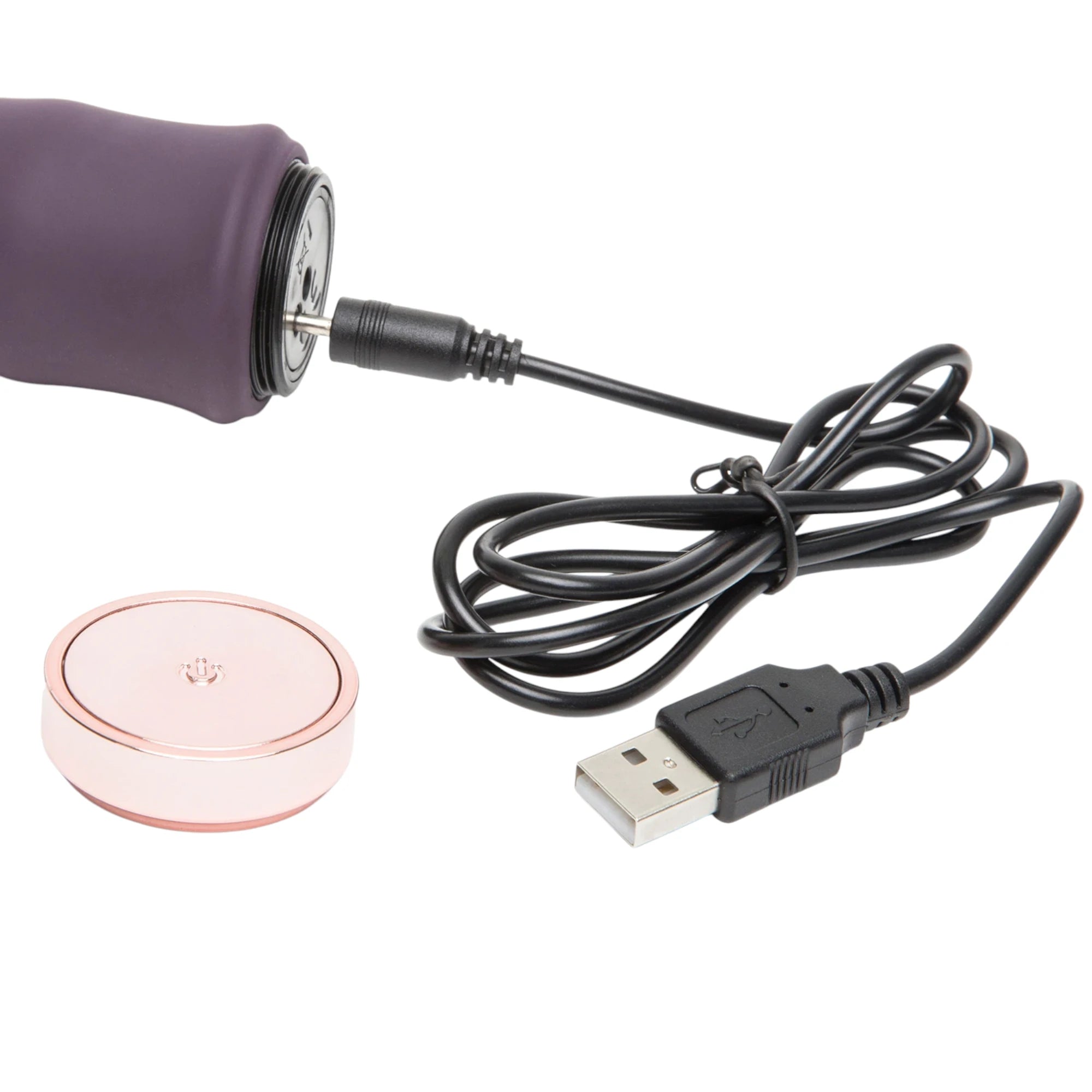 Fifty Shades Freed Deep Inside Classic Wave vibrator charging setup shown with the rose-gold magnetic charging base, USB cable and the charging plug connected to the vibrator base against a white background