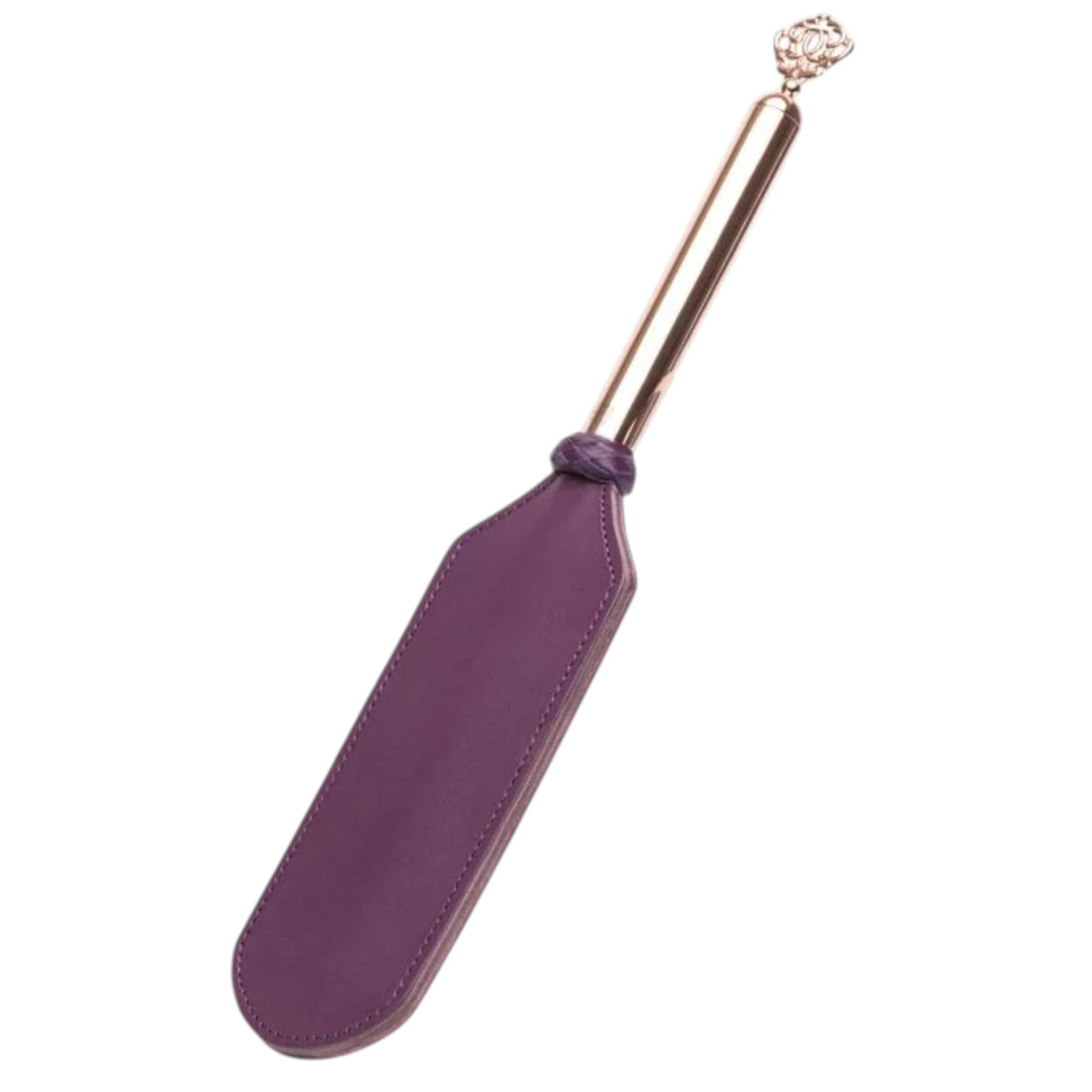 Fifty Shades Freed Cherished Collection leather and suede paddle shown at an angle, featuring a purple stitched paddle head and a rose-gold handle topped with an ornate key-shaped charm against a white background