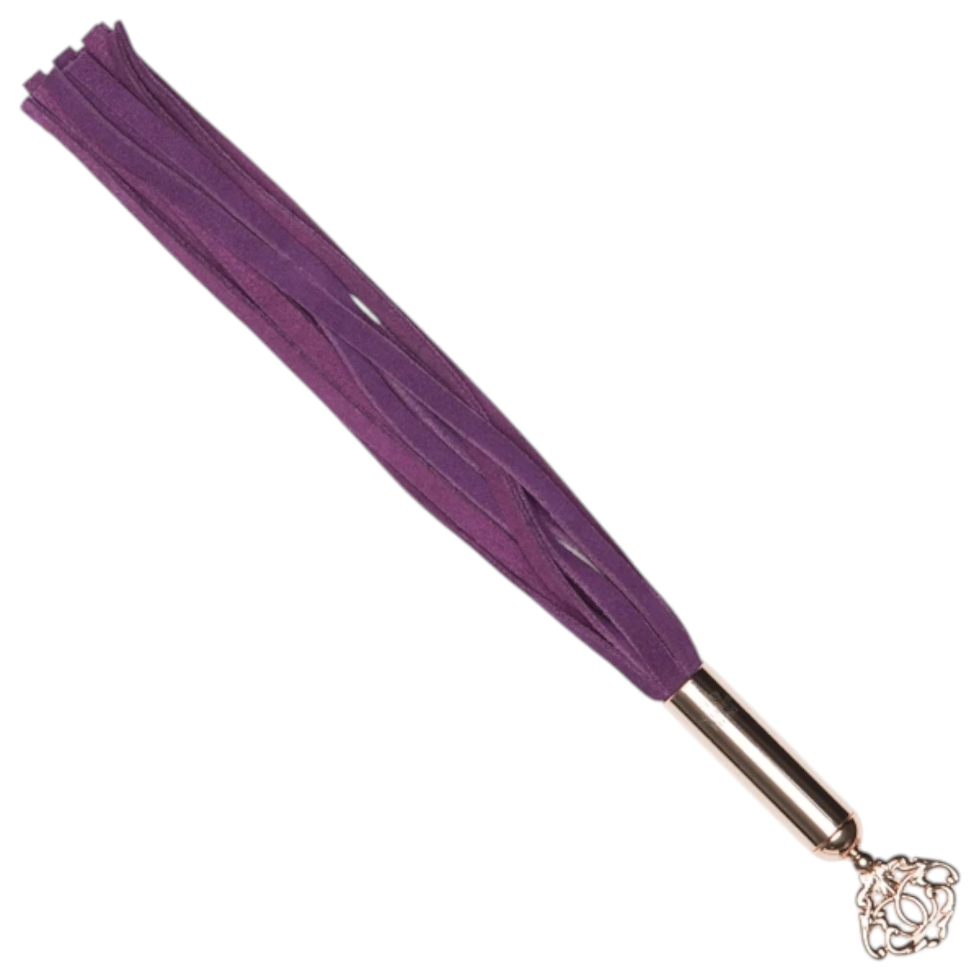 Fifty Shades Freed Cherished Collection mini flogger shown at an angle, featuring short purple faux-leather tails attached to a rose-gold handle with an ornate key-shaped charm at the end against a white background.