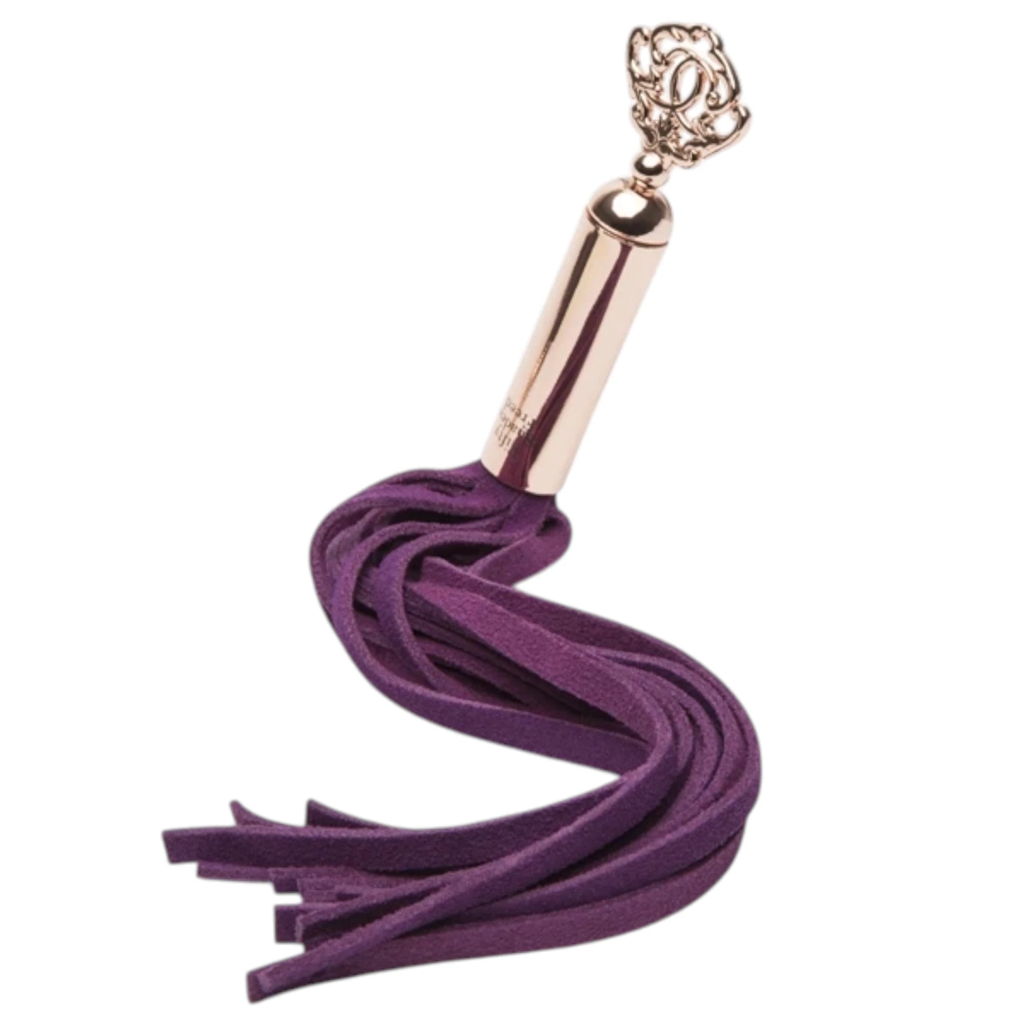 Fifty Shades Freed Cherished Collection mini flogger shown coiled, featuring short purple faux-leather tails attached to a rose-gold handle with an ornate key-shaped charm at the end against a white background.