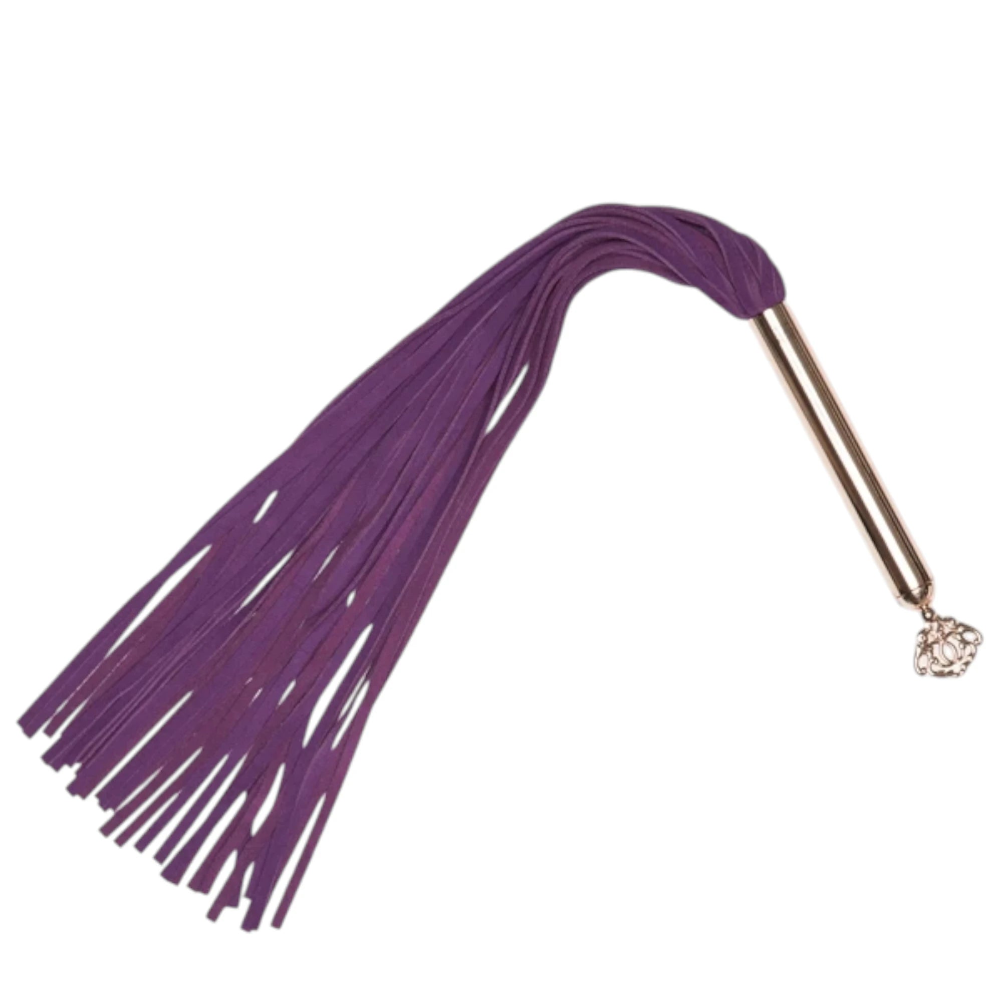 Fifty Shades Freed Cherished Collection flogger with multiple purple faux-leather tails and a rose-gold handle, finished with a small decorative key charm at the end against a white background