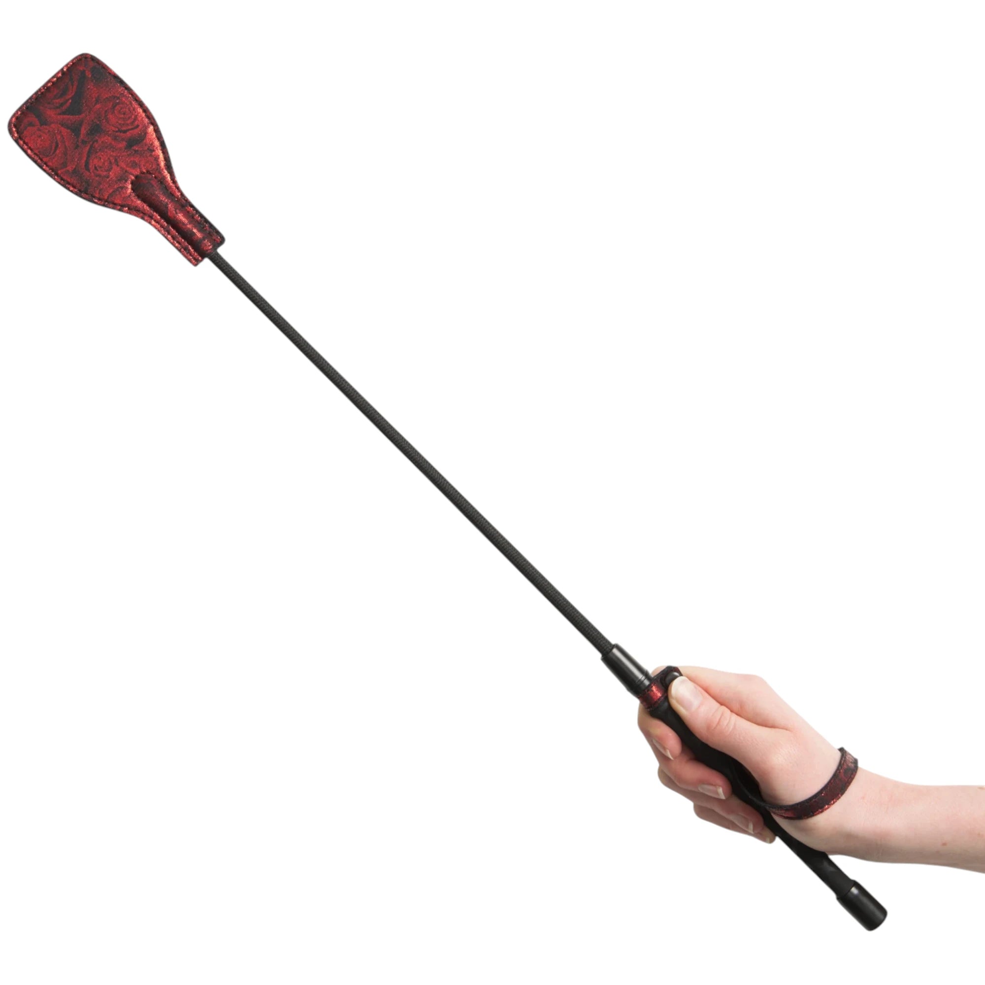 Hand holding the Fifty Shades of Grey Sweet Anticipation riding crop on a white background