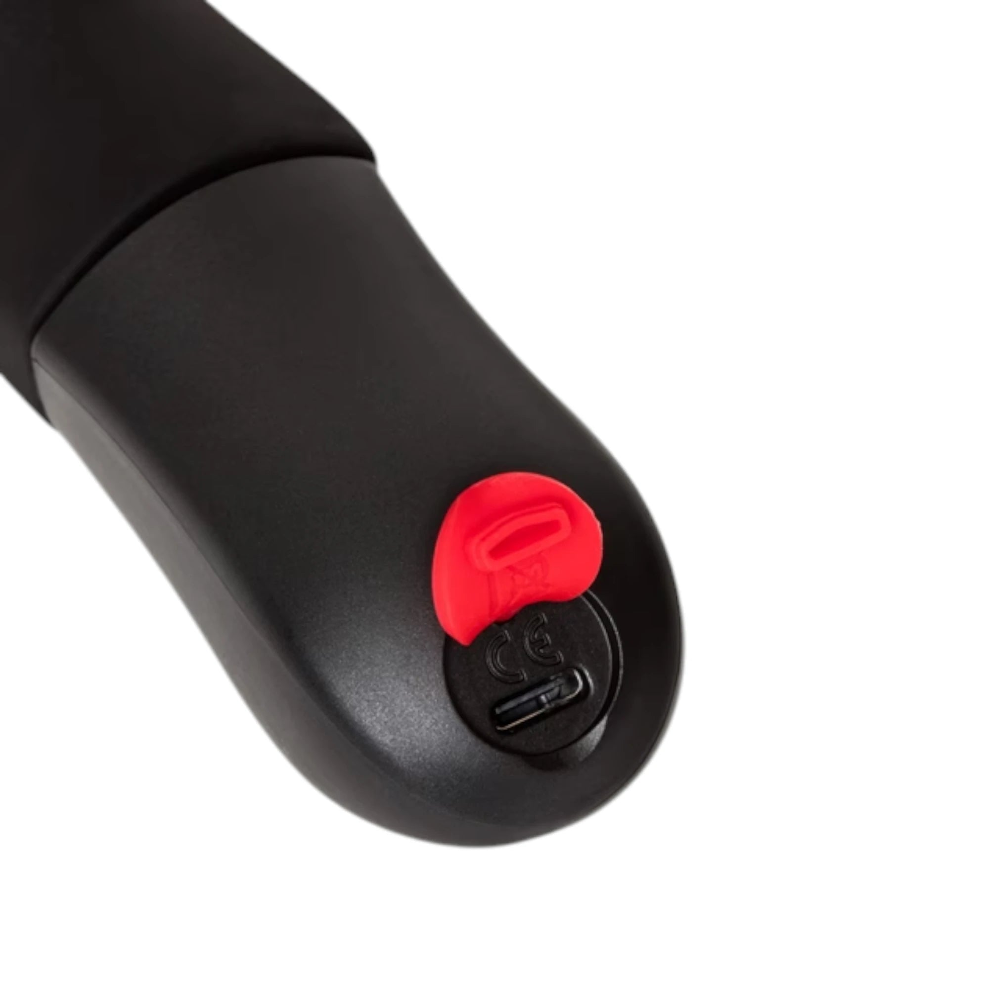 Fun Factory Stronic Real black realistic thrusting vibrator shown from base displaying red power button and USB charging port against white background