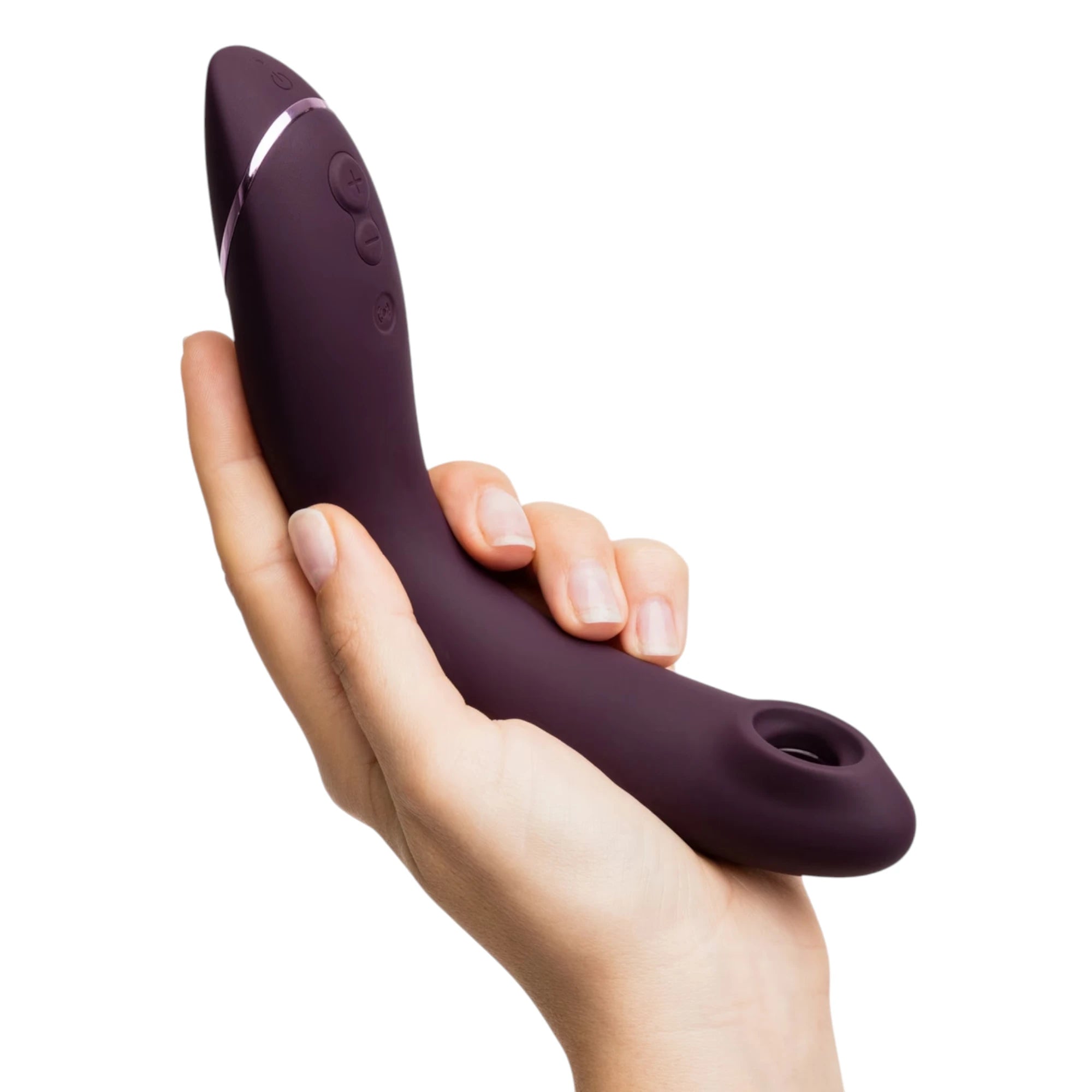 Womanizer OG Pleasure Air G-spot stimulator in purple shown held in a hand, highlighting the curved ergonomic shape, metallic accent band, side control buttons and the Pleasure Air nozzle opening at the tip against a white background
