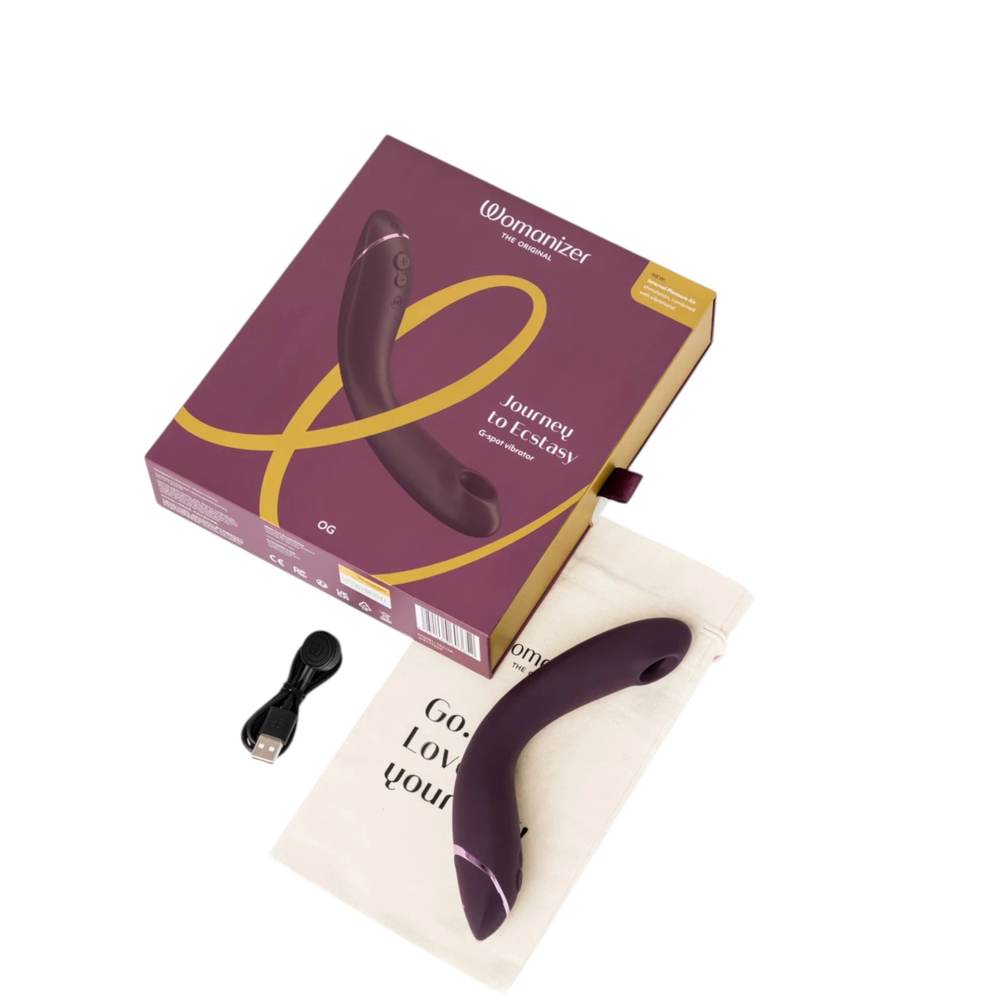 Womanizer OG Pleasure Air G-spot stimulator set shown with the purple retail box, the purple OG device, a fabric storage pouch and a USB charging cable laid out on a white background