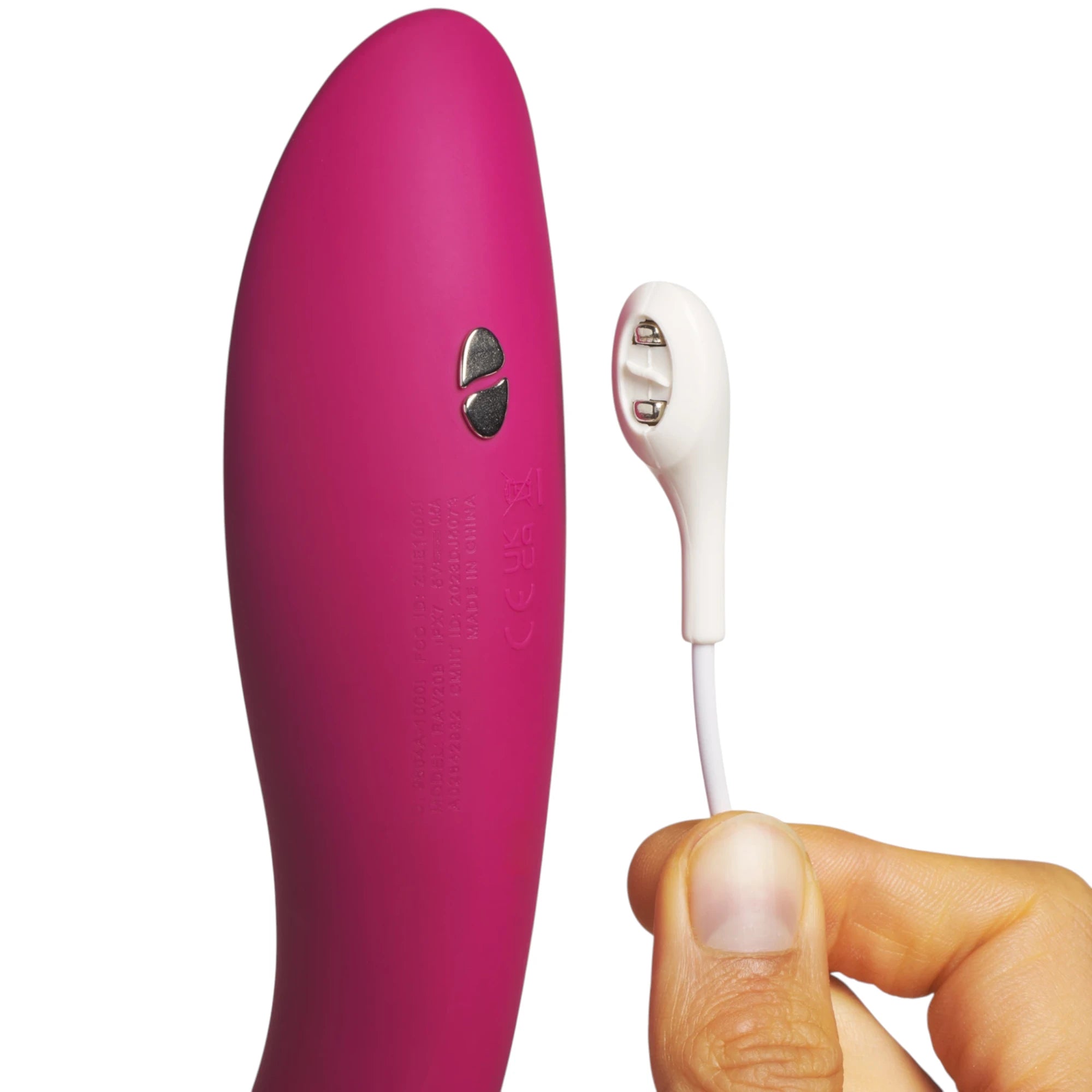 We-Vibe Rave 2 G-spot vibrator in magenta shown from front displaying curved tapered body, control buttons, and smooth silicone finish, displayed with white charging cable held in hand against white background