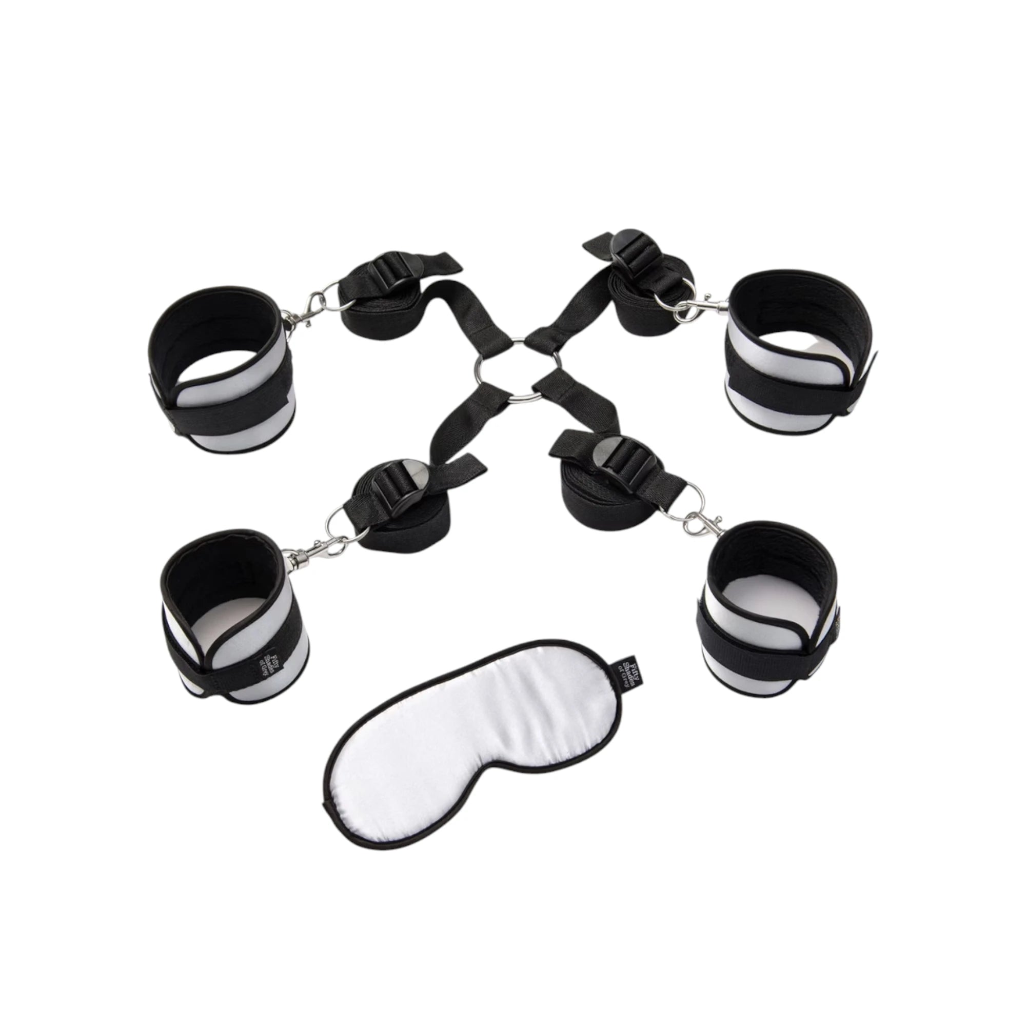 Fifty Shades of Grey Hard Limits bed restraint kit shown from above displaying four black and white padded wrist and ankle cuffs with silver metal chains and connectors, white padded eye mask, and adjustable nylon straps against white background
