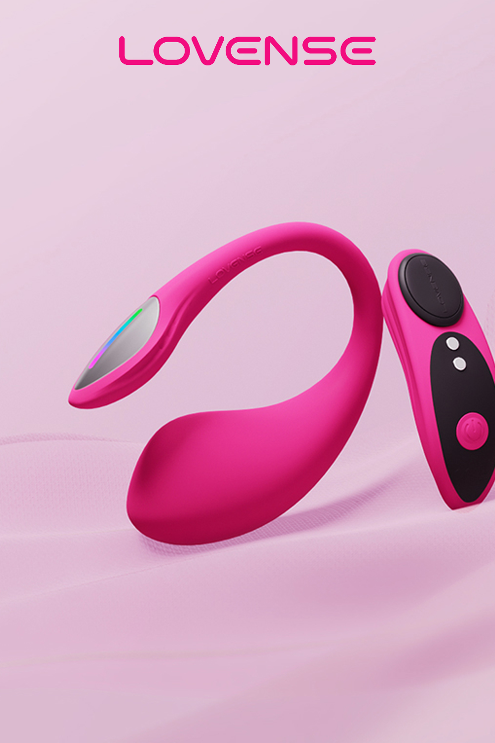 Lovense Lush 4 app-controlled G-spot vibrator in vibrant hot pink silicone with a curved ergonomic handle, rounded insertable bulb, and an attached black remote control with white button accents and a pink circular control pad; the toy and remote are displayed against a soft pale pink gradient background; the Lovense logo in hot pink sans-serif text is positioned at the top of the image