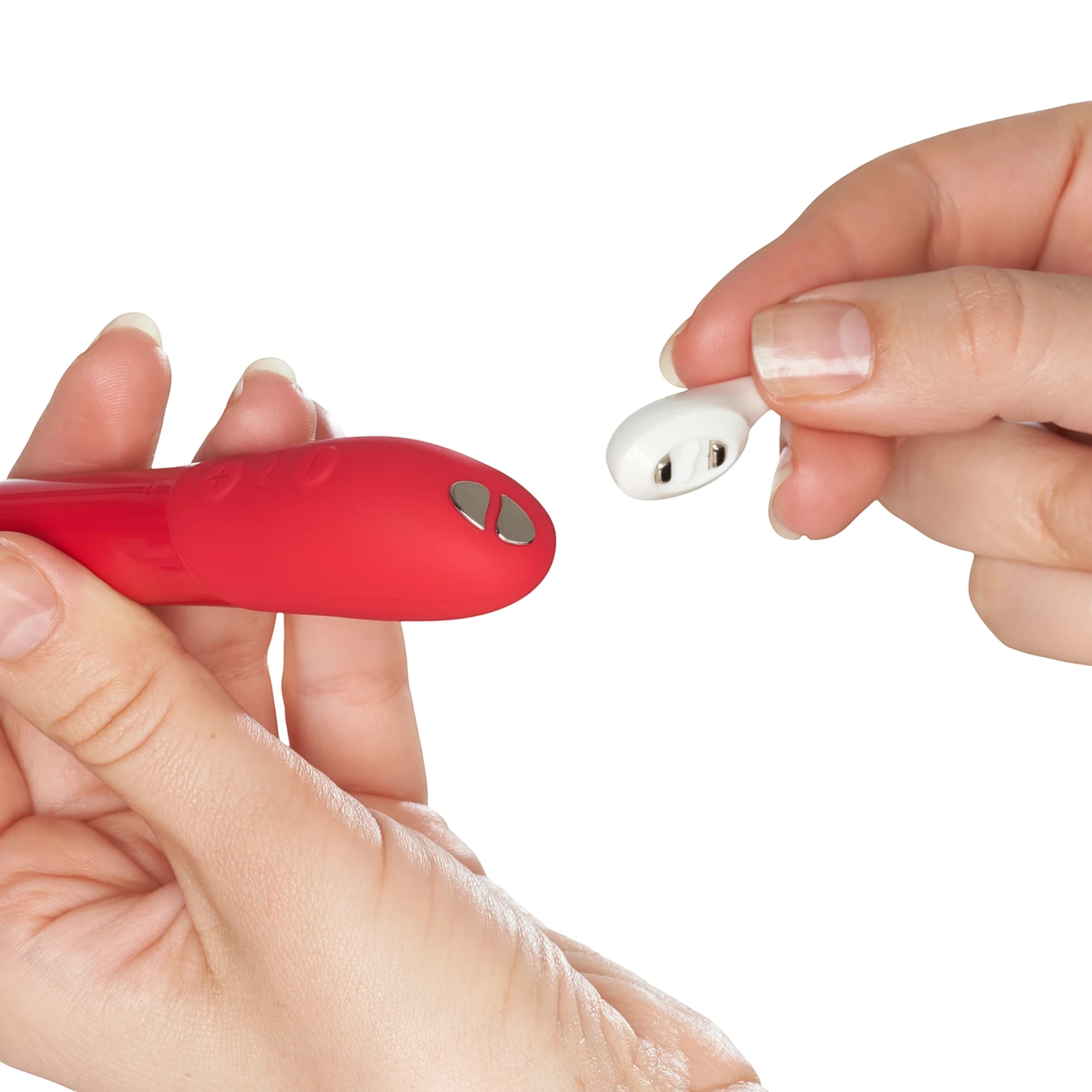 We-Vibe Tango X red lipstick bullet vibrator with white wireless remote control held in hands against white background